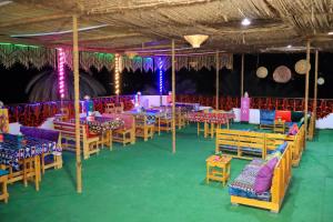 a banquet hall with tables and chairs and lights at BAYT ZAINA - Nubian hospitality house in Aswan