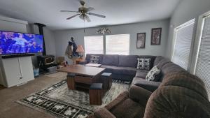 a living room with a couch and a flat screen tv at El Paraiso at Island Park in Island Park