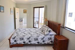 a bedroom with a bed and a window at Paragon Apartment 6 - Bring your own linen. in South West Rocks