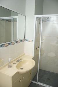 a bathroom with a sink and a shower at Paragon Apartment 6 - Bring your own linen. in South West Rocks +12 photos
