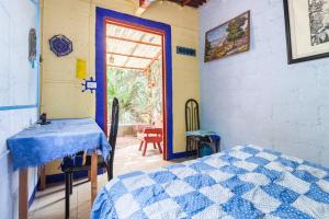 a bedroom with a bed and a door with a window at Casa Ecológica in Tepoztlán