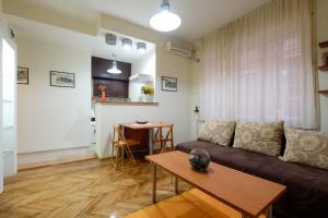 a living room with a couch and a table at M&M Downtown Apartment in Belgrade