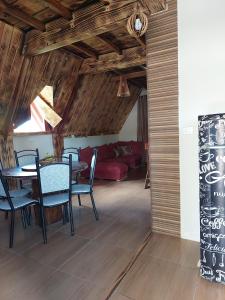 a living room with a table and chairs and a couch at Chalé bom jardim in Ibicoara +13 photos