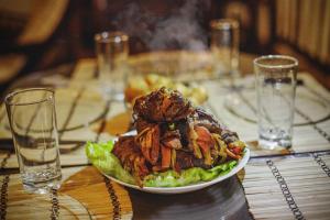 a plate of food on a table with a salad at Kazasha Terra in Barichara