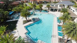 an overhead view of a swimming pool at a resort at Deluxe themed private ROOMS - Ensuite Bath & Pool Access by Casa Da Jura in Kissimmee