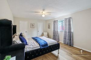 a bedroom with a bed with blue sheets and a window at AT&T, Globe Life, Six Flags - Updated Comfy Home in Grand Prairie