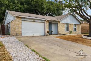 a brick house with a white garage at AT&T, Globe Life, Six Flags - Updated Comfy Home in Grand Prairie