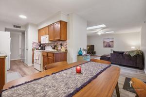 a kitchen and living room with a table in a room at AT&T, Globe Life, Six Flags - Updated Comfy Home in Grand Prairie