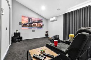 a living room with a couch and a table at Palamcotta Lodge in Moama +25 photos