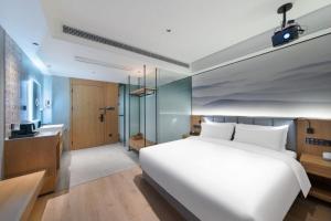 Posteľ alebo postele v izbe v ubytovaní Qiuguo Hotel Chongqing Guanyin Bridge Branch
