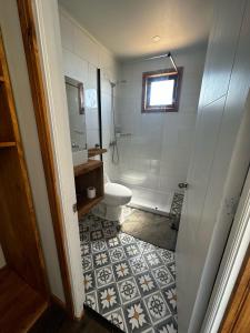 a bathroom with a toilet and a sink and a shower at Casa Olas, Refugio Costero in Curanipe