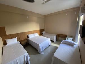 a hotel room with two beds at Hotel Primavera Palace in Salinas