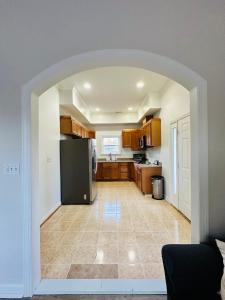 a large kitchen with a black refrigerator in a room at New Oasis by DC in Hyattsville