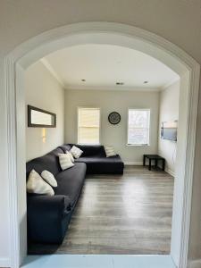 a living room with a black couch in a room at New Oasis by DC in Hyattsville