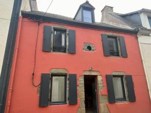 a red building with black windows and a door at Charmante maison familiale à Groix, 3 chambres - FR-1-813-5 in Groix