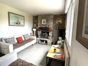 a living room with a couch and a fireplace at Maison familiale proche plage Groix, jardin et garage - FR-1-813-6 in Groix