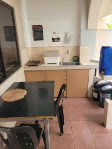 a small kitchen with a table and a sink at Tara Staycation 2 in Boracay