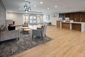 a lobby with a waiting area with chairs and a table at Candlewood Suites Chattanooga - East Ridge by IHG in Chattanooga