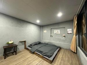 a bedroom with a bed and a table in it at Bãi dài Camping in Nha Trang