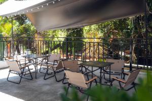 a group of tables and chairs on a patio at Gulangyu Sunlit Rock Garden Resort in Xiamen