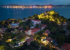 an aerial view of a city and the water at night at Gulangyu Sunlit Rock Garden Resort in Xiamen