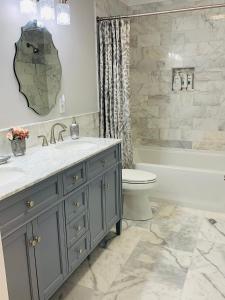 a bathroom with a sink and a toilet and a tub at Travelers Rest Treasure - Sleeps 8 - 3 Bedroom 2 Bath - Pets Welcome in Travelers Rest +24 photos