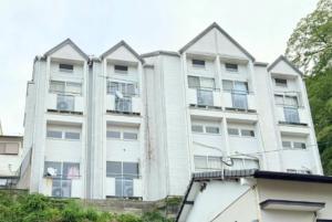 a white apartment building with a lot of windows at 高平ハウス Room106 in Nagasaki +21 photos