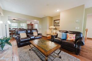 sala de estar con muebles de cuero y mesa en The Rose cabin, en Gatlinburg 121 fotos más