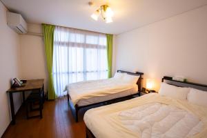 Katil atau katil-katil dalam bilik di Bigstone Terrace suite　堤町