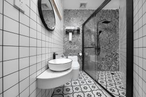 a bathroom with a toilet and a sink and a shower at Gulangyu Sunlit Rock Garden Resort in Xiamen
