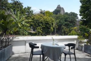 a table and chairs on a balcony with a view at Gulangyu Sunlit Rock Garden Resort in Xiamen