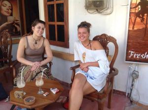 two women sitting in chairs next to a table at Saman Homestay in Tangalle