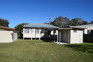 a house with a garage in a yard at Lumeah - Bring your own linen in Hat Head