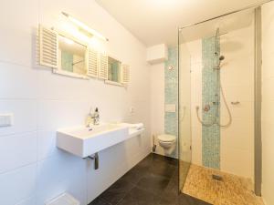 a bathroom with a sink and a shower at Villa near Teuge Airport and Paleis 't Loo in Teuge +32 photos