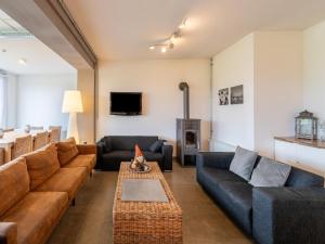 a living room with a couch and a table at Villa near Teuge Airport and Paleis 't Loo in Teuge