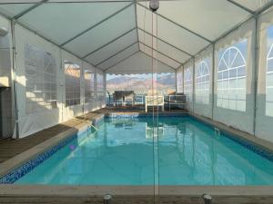 a large swimming pool in a building with a marquee at villalis in Eilat