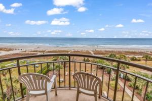 a balcony with two chairs and the beach at Oceanfront Condo at Meridian Plaza in Myrtle Beach