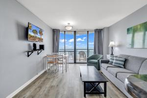 a living room with a couch and a table at Oceanfront Condo at Meridian Plaza in Myrtle Beach