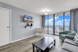 a living room with a couch and a table at Oceanfront Condo at Meridian Plaza in Myrtle Beach +28 photos