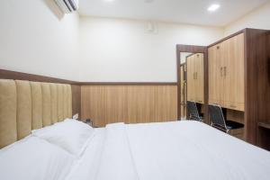Postel nebo postele na pokoji v ubytování Hotel PRM Aruna Archadia