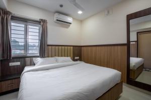 Postel nebo postele na pokoji v ubytování Hotel PRM Aruna Archadia