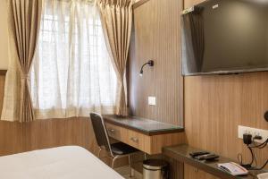 TV a/nebo společenská místnost v ubytování Hotel PRM Aruna Archadia