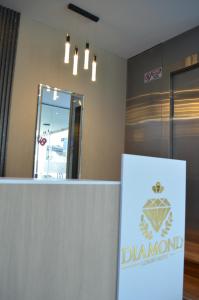 a sign in front of a dermatologist office with a mirror at Hotel Diamond Luxury Tunja in Tunja