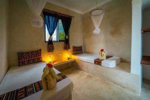 Postel nebo postele na pokoji v ubytování Blooming Zanzibar