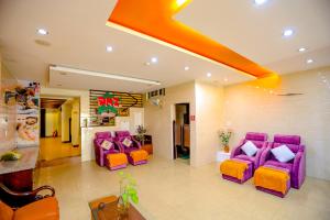 a lobby with purple chairs and a waiting room at DMZ Hotel ,Central Hue ,Near Perfume River in Hue