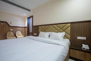 Postel nebo postele na pokoji v ubytování Hotel PRM Aruna Archadia