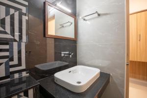 Koupelna v ubytování Hotel PRM Aruna Archadia
