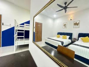 a bedroom with a mirror and a bunk bed at La Mensa Families Cheerful Residences in Ulu Melaka