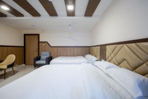 Postel nebo postele na pokoji v ubytování Hotel PRM Aruna Archadia