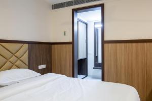 Postel nebo postele na pokoji v ubytování Hotel PRM Aruna Archadia
